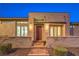 Inviting front entry with stone facade, brick walkway, and modern lighting creates a welcoming ambiance at 4273 Sunrise Flats St, Las Vegas, NV 89135
