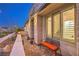 Charming covered front porch with brick flooring and a cozy seating area to enjoy the outdoors at 4273 Sunrise Flats St, Las Vegas, NV 89135
