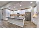 Modern kitchen with white cabinetry, stainless steel appliances, and an expansive island with stone countertops at 4273 Sunrise Flats St, Las Vegas, NV 89135