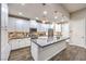 Well-equipped kitchen with white cabinets, a large island with seating, and stylish pendant lighting at 4273 Sunrise Flats St, Las Vegas, NV 89135