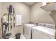 Functional laundry room with washer, dryer, and storage for cleaning supplies at 4273 Sunrise Flats St, Las Vegas, NV 89135