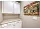 The laundry room offers counter and cabinet space and modern overhead lighting at 4273 Sunrise Flats St, Las Vegas, NV 89135