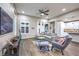 Open-concept living room with modern decor, wood-look tile flooring, and plenty of natural light at 4273 Sunrise Flats St, Las Vegas, NV 89135