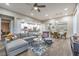 Open-concept living room featuring hardwood floors, modern decor, and seamless flow to the dining and kitchen areas at 4273 Sunrise Flats St, Las Vegas, NV 89135