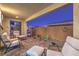 Inviting covered patio features brick pavers, desert landscaping, and stylish outdoor seating at 4273 Sunrise Flats St, Las Vegas, NV 89135