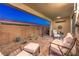 Relaxing covered patio boasts desert landscaping, brick pavers, and comfortable seating area at 4273 Sunrise Flats St, Las Vegas, NV 89135