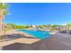 Community pool with lush landscaping and lounge chairs at 4273 Sunrise Flats St, Las Vegas, NV 89135