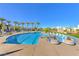 Community pool with palm trees, lounge chairs and water feature at 4273 Sunrise Flats St, Las Vegas, NV 89135
