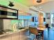 Compact, modern kitchen with stainless steel cabinets, appliances, and pendant lighting at 4381 W Flamingo Rd # 12304, Las Vegas, NV 89103