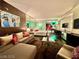 Well-lit living room featuring a sofa, desk, and a well-equipped kitchenette in the background at 4381 W Flamingo Rd # 12304, Las Vegas, NV 89103
