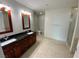 Modern bathroom featuring double sinks, a glass-enclosed shower, and tile flooring at 4525 Dean Martin Dr # 911, Las Vegas, NV 89103