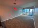 Bright living room with carpet, modern lighting, and large windows at 4525 Dean Martin Dr # 911, Las Vegas, NV 89103