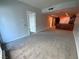 Open living room with carpet, neutral paint, and kitchen bar area in view at 4525 Dean Martin Dr # 911, Las Vegas, NV 89103