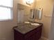 Bright bathroom with a granite countertop, dual sinks, and large mirrors at 4601 Diamond Head Dr, Las Vegas, NV 89110