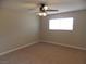 Neutral bedroom with neutral carpet, ceiling fan, and a large window at 4601 Diamond Head Dr, Las Vegas, NV 89110