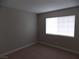 Neutral bedroom with neutral carpet and a bright window at 4601 Diamond Head Dr, Las Vegas, NV 89110