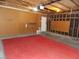 Spacious garage with unfinished walls and ceiling and red carpet at 4601 Diamond Head Dr, Las Vegas, NV 89110