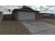 Exterior view featuring a two-car garage, concrete driveway, and minimal desert landscaping at 4601 Diamond Head Dr, Las Vegas, NV 89110