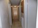 Long hallway with tile flooring and neutral colored walls at 4601 Diamond Head Dr, Las Vegas, NV 89110