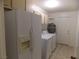 Bright laundry room features washer, dryer, water heater, and refrigerator at 4601 Diamond Head Dr, Las Vegas, NV 89110