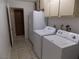 Functional laundry room with appliances and storage cabinets at 4601 Diamond Head Dr, Las Vegas, NV 89110