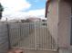 Side yard features desert landscaping, a metal gate, and concrete block wall for privacy at 4601 Diamond Head Dr, Las Vegas, NV 89110