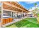 Charming backyard featuring covered patio, well-manicured lawn, and hot tub at 4730 Mountain Valley Rd, Las Vegas, NV 89121