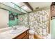 Bathroom featuring unique vanity with ornate mirror and patterned shower curtain at 4730 Mountain Valley Rd, Las Vegas, NV 89121