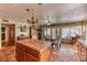 Bright kitchen and dining area with tile floors, central island and classic chandelier above the dining table at 4730 Mountain Valley Rd, Las Vegas, NV 89121