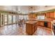 Spacious kitchen featuring tile flooring, wooden cabinetry, and a center island, perfect for cooking and entertaining at 4730 Mountain Valley Rd, Las Vegas, NV 89121