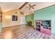 Upstairs living room featuring wood floors, ample lighting, and vaulted ceiling at 4730 Mountain Valley Rd, Las Vegas, NV 89121