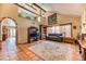 A spacious living room featuring tile flooring, exposed beams, and an archway, adding architectural interest to the home at 4730 Mountain Valley Rd, Las Vegas, NV 89121