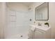 Bright bathroom featuring a modern vanity, framed mirror, and a clean, white shower at 4790 E Cleveland Ave, Las Vegas, NV 89104