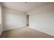 Bedroom showcasing neutral carpet and white walls, with an open closet door at 4790 E Cleveland Ave, Las Vegas, NV 89104