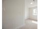 This is a bright bedroom, with a neutral carpet, a window, and a fresh coat of white paint at 4790 E Cleveland Ave, Las Vegas, NV 89104