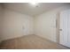 A modest bedroom features neutral carpet, white walls, and a door to the outside at 4790 E Cleveland Ave, Las Vegas, NV 89104