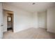 A bedroom is shown with neutral carpet, white walls, and an open door to the on-suite bathroom at 4790 E Cleveland Ave, Las Vegas, NV 89104