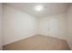 A modest bedroom features neutral carpet, white walls, and a door to the outside at 4790 E Cleveland Ave, Las Vegas, NV 89104