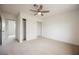 This bedroom includes a ceiling fan, neutral carpet, white walls and closet access at 4790 E Cleveland Ave, Las Vegas, NV 89104