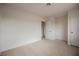 A bedroom is shown featuring neutral carpet, white walls and access to the closet and hallway at 4790 E Cleveland Ave, Las Vegas, NV 89104