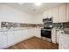 Bright kitchen with white cabinets, stainless steel appliances, granite countertops and decorative backsplash at 4790 E Cleveland Ave, Las Vegas, NV 89104