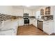 Bright kitchen with white cabinets, stainless steel appliances, granite countertops and decorative backsplash at 4790 E Cleveland Ave, Las Vegas, NV 89104
