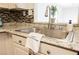 Close-up of a modern kitchen sink with stylish fixtures, granite countertops, and a decorative backsplash at 4790 E Cleveland Ave, Las Vegas, NV 89104