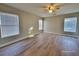 Spacious bedroom featuring a ceiling fan, natural light, and wood-look flooring at 4823 Jubilee Diamond Ct, Las Vegas, NV 89139