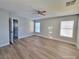 Large bedroom featuring a ceiling fan, natural light, and wood-look flooring at 4823 Jubilee Diamond Ct, Las Vegas, NV 89139