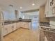 Functional kitchen design with white cabinets, granite countertops, and tile flooring open to living spaces at 4823 Jubilee Diamond Ct, Las Vegas, NV 89139