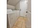 Convenient laundry room with washer and dryer, tiled floor, and practical layout for easy chore management at 4823 Jubilee Diamond Ct, Las Vegas, NV 89139