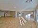 Open living room showcasing tile flooring, neutral paint, and a glimpse of the kitchen and staircase at 4823 Jubilee Diamond Ct, Las Vegas, NV 89139