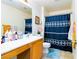 Compact bathroom has a single sink vanity, toilet, and shower with curtain at 5040 Copperlyn St, Las Vegas, NV 89122
