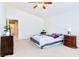 Bright bedroom with vaulted ceilings, ceiling fan and furnished with dressers and a bed at 5040 Copperlyn St, Las Vegas, NV 89122